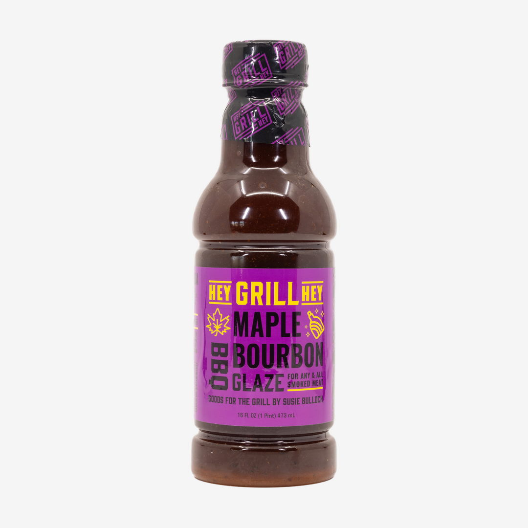 A bottle of Maple Bourbon BBQ Glaze on a white background.
