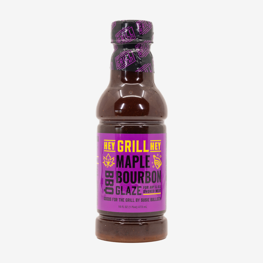A bottle of Maple Bourbon BBQ Glaze on a white background. 