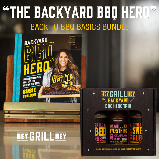 Backyard BBQ Hero Back to BBQ Basics Bundle featuring the book 'Backyard BBQ Hero' by Susie Balloch and the Hey Grill Hey BBQ Hero Trio seasoning bottles in a black gift box.
