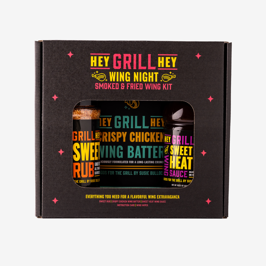 Hey Grill Hey Wing Night Smoked & Fried Wing Kit box against a white background. The Box reads "Hey Grill Hey Wing Night Smoked & Fried Wing Kit. Everything you need for a flavorful wing extravaganza. Sweet Rub. Crispy Chicken Wing Batter. Sweet Heat Wing Sauce. Instruction Card. Wing Wipes."
